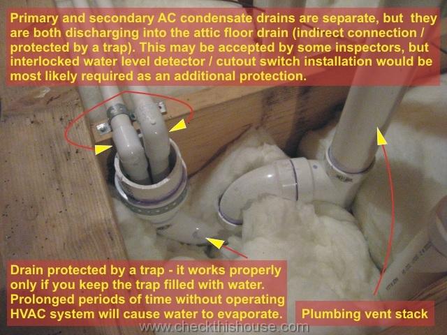 Picture of the primary and secondary AC condensate drains discharging into the attic floor drain equipped with a trap