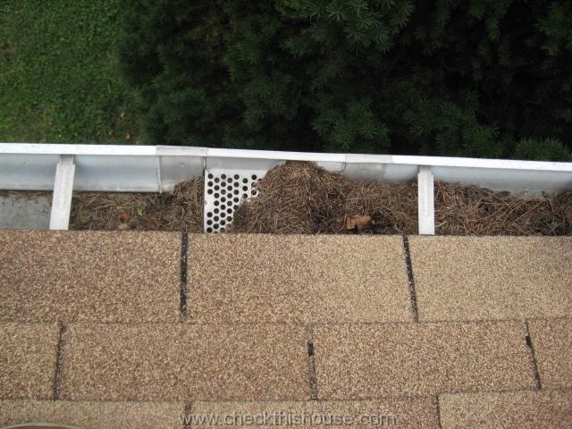 Rain gutter downspout - gutter strainers require cleaning