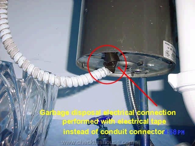 Garbage disposal wiring performed with electrical tape instead of conduit connector