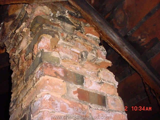 Heavy deteriorated attic section of the house brick chimney