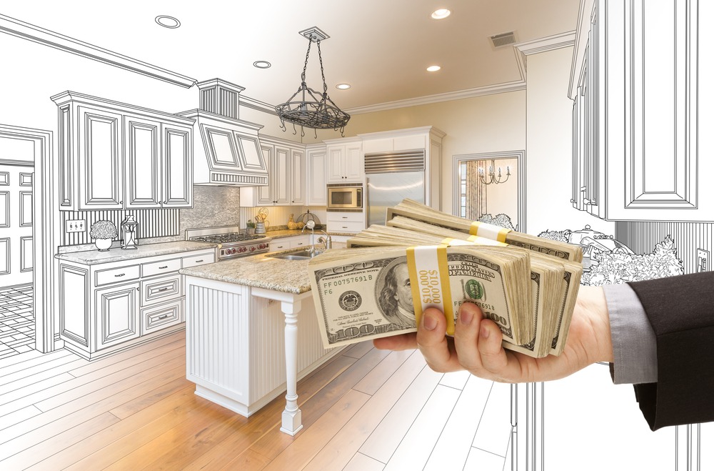 Hand Handing Stacks of Money Over Custom Kitchen Design Drawing and Photo Combination