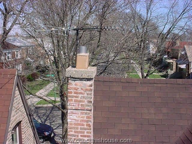 Leaning brick chimney, caused by the attached TV antenna