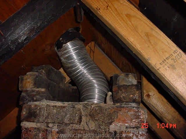 Partially missing attic section of the house brick chimney, exposed liner