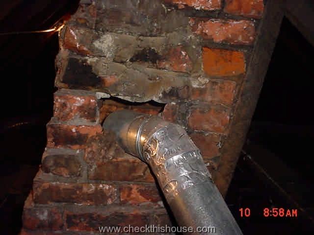 Single wall vent pipe in attic area improperly attached to the old house brick chimney, missing chimney liner