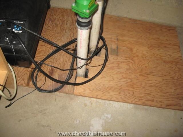 Two piece plywood cover on a house sump pump well