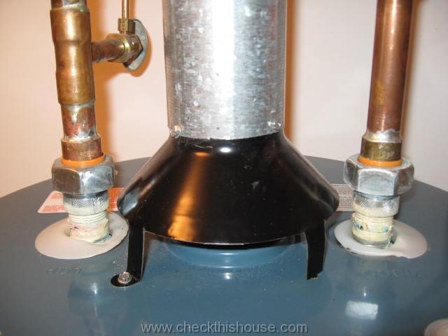 Water heater vent pipe and draft hood properly secured with screws